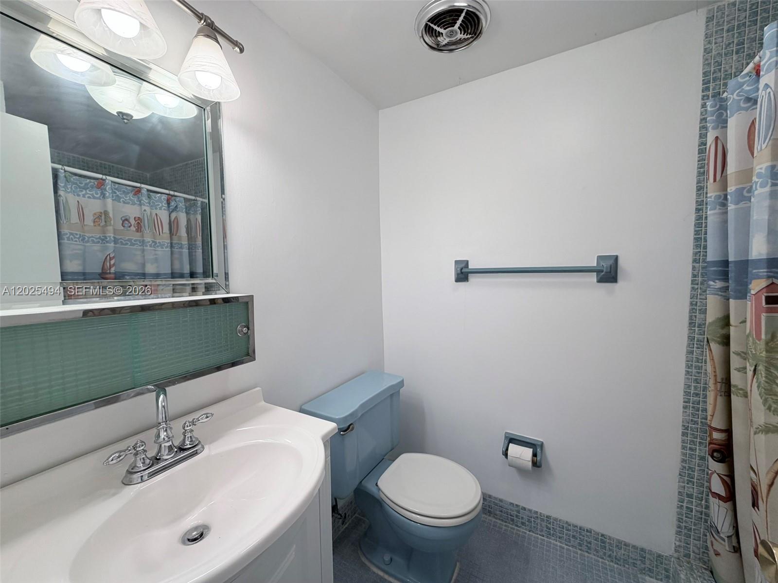 9159 Southwest 77th Avenue, Unit 112 Miami, FL 33156 - Photo 19 of 38 a bathroom with a sink and a mirror