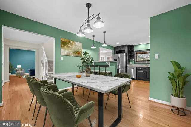 a view of a dining room with furniture and wooden floor