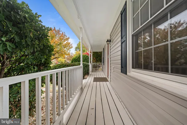 a view of balcony with wooden floor and fence