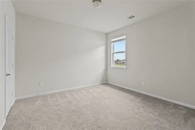 a view of an empty room with windows