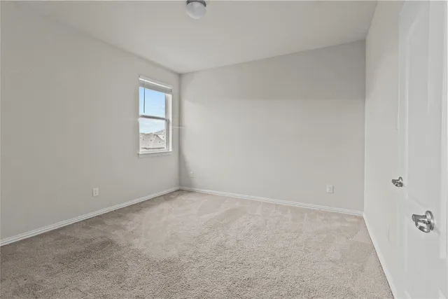 a view of an empty room with windows
