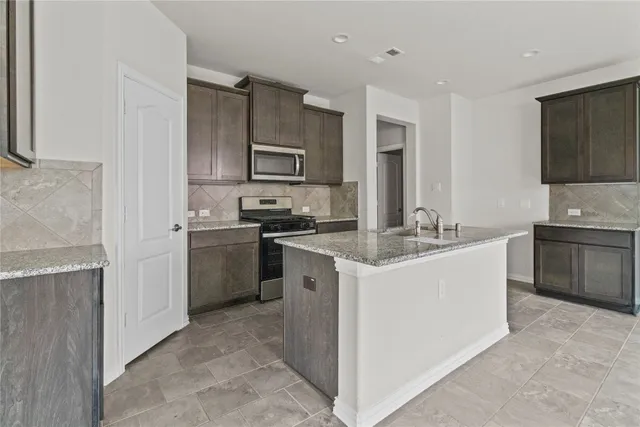 a kitchen with a sink stove and refrigerator