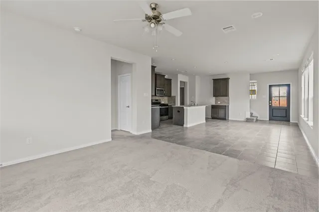 an empty room with a cabinet and mirrors