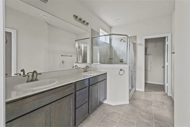 a bathroom with a double vanity sink mirror and