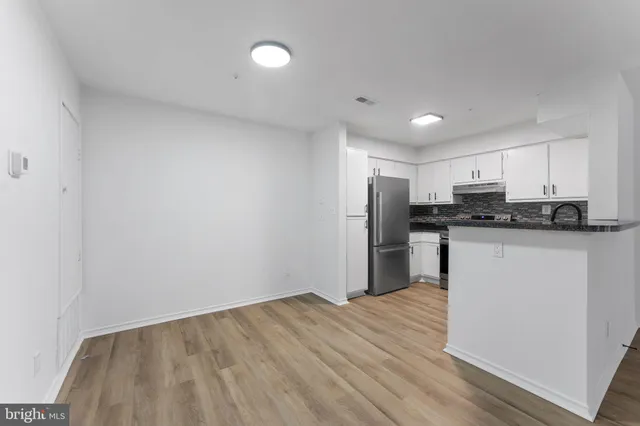 a kitchen with stainless steel appliances granite countertop a stove and a refrigerator
