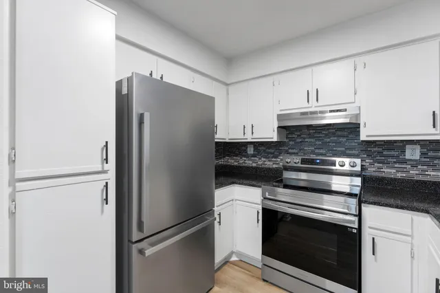 a kitchen that has a sink and a stove