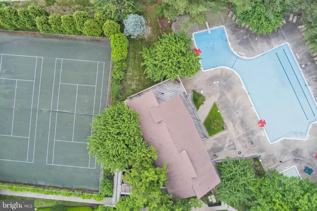 aerial view of a swimming pool with a patio