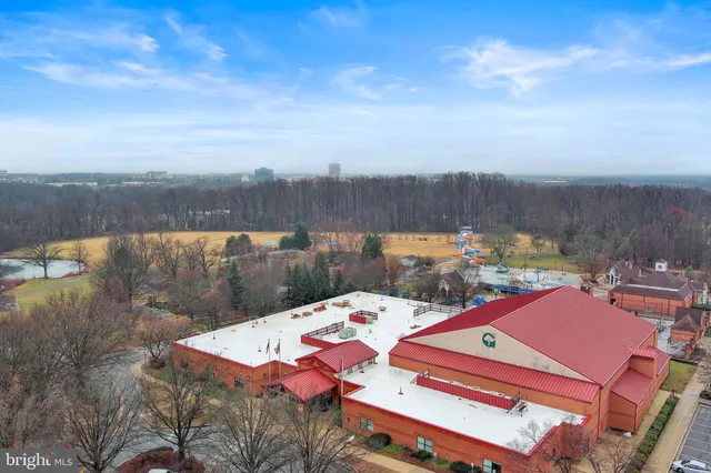 a view of a big house with a big yard and large trees