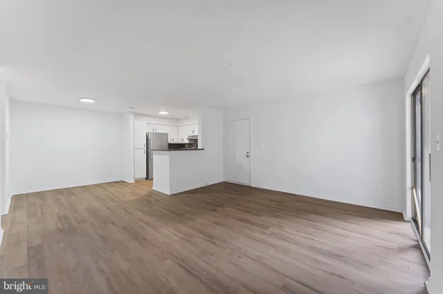 a view of an entryway with wooden floor and windows