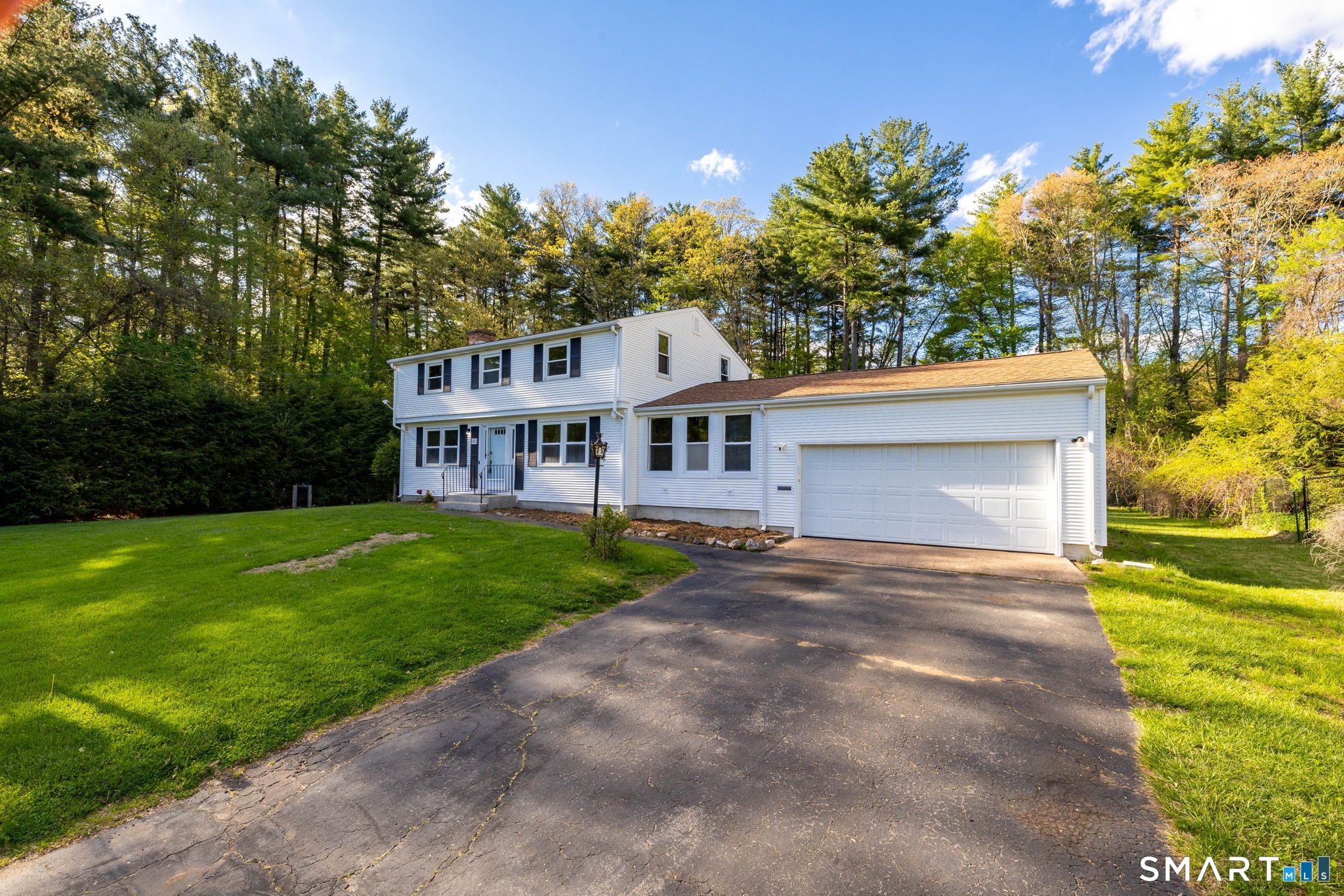 50 Brook Road Enfield, CT 06082 - Photo 1 of 34 a front view of a house with a yard and garage