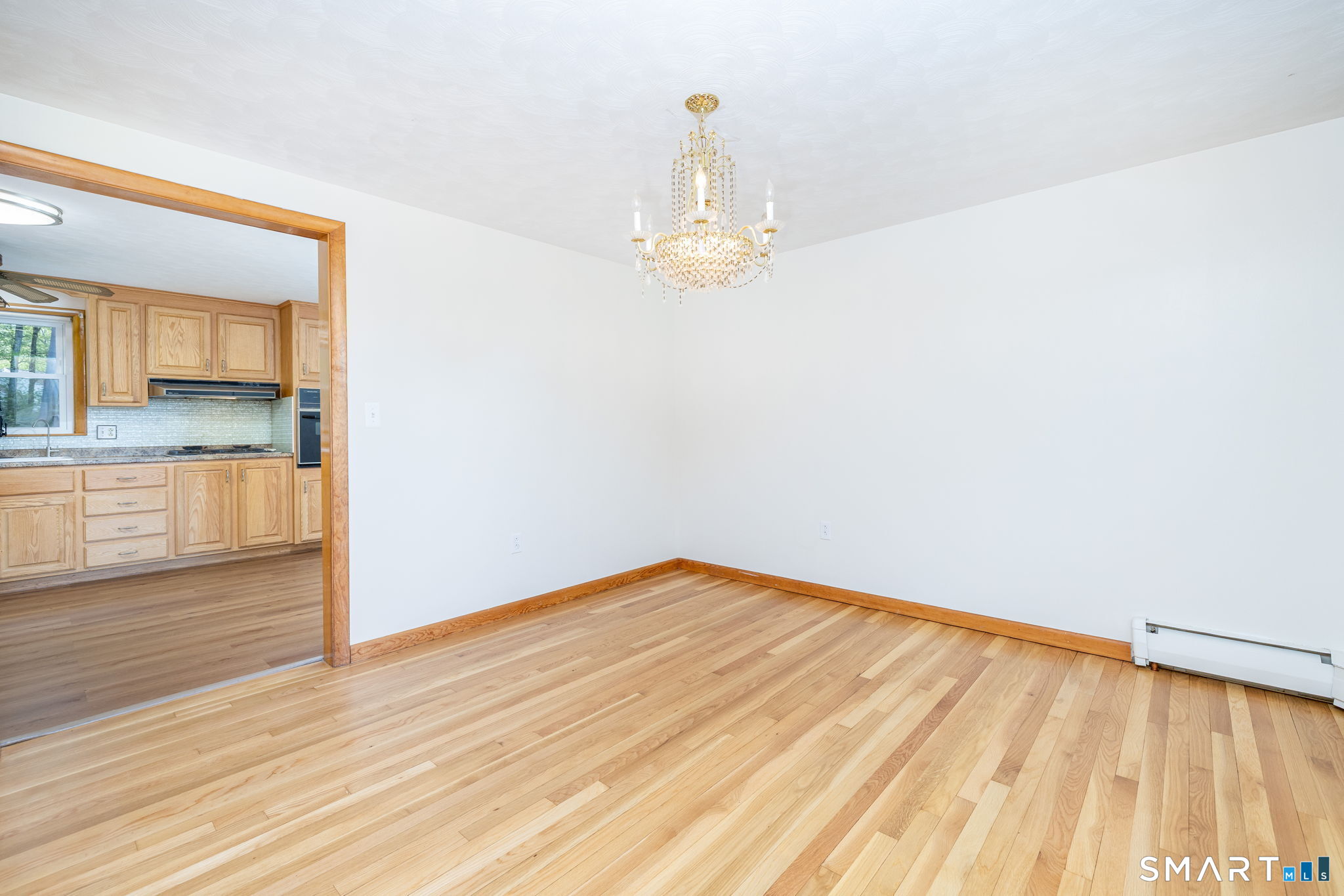 50 Brook Road Enfield, CT 06082 - Photo 11 of 34 a view of empty room with wooden floor and fan