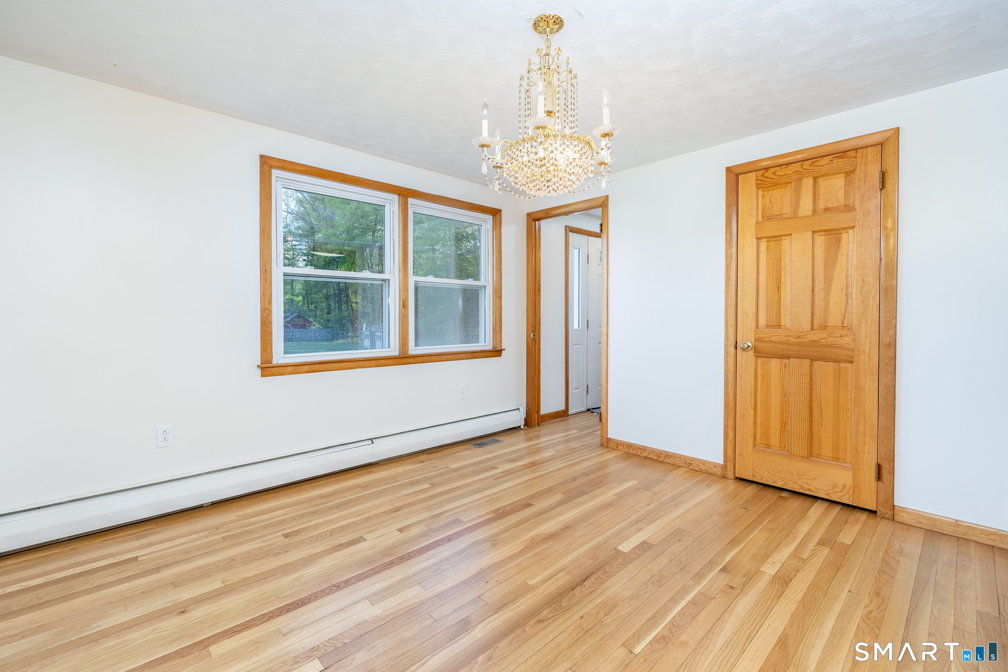 50 Brook Road Enfield, CT 06082 - Photo 12 of 34 an empty room with wooden floor cabinet and windows