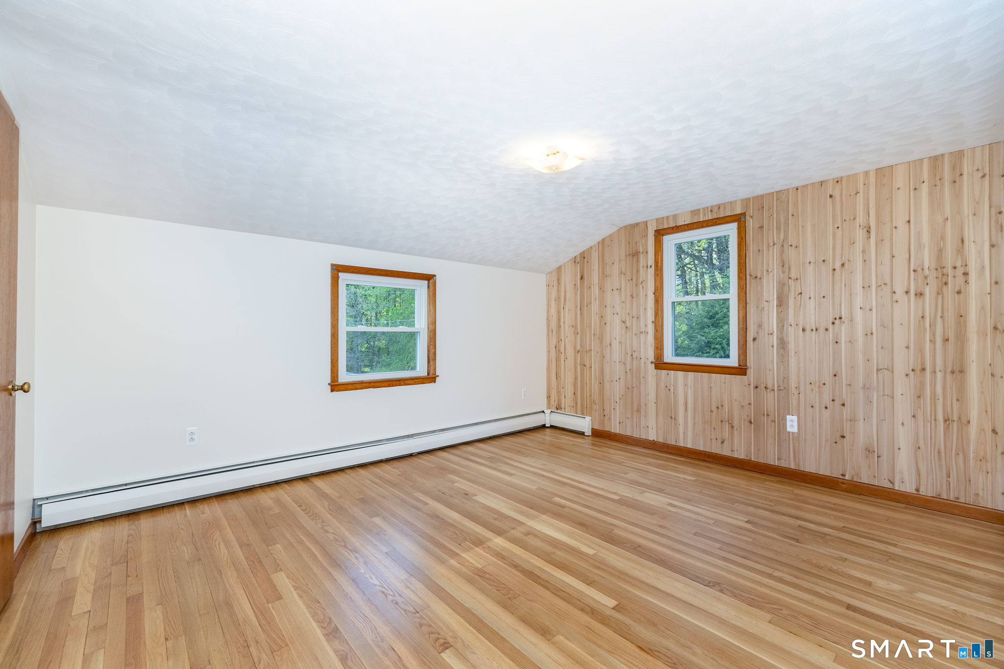 50 Brook Road Enfield, CT 06082 - Photo 17 of 34 an empty room with wooden floor and windows