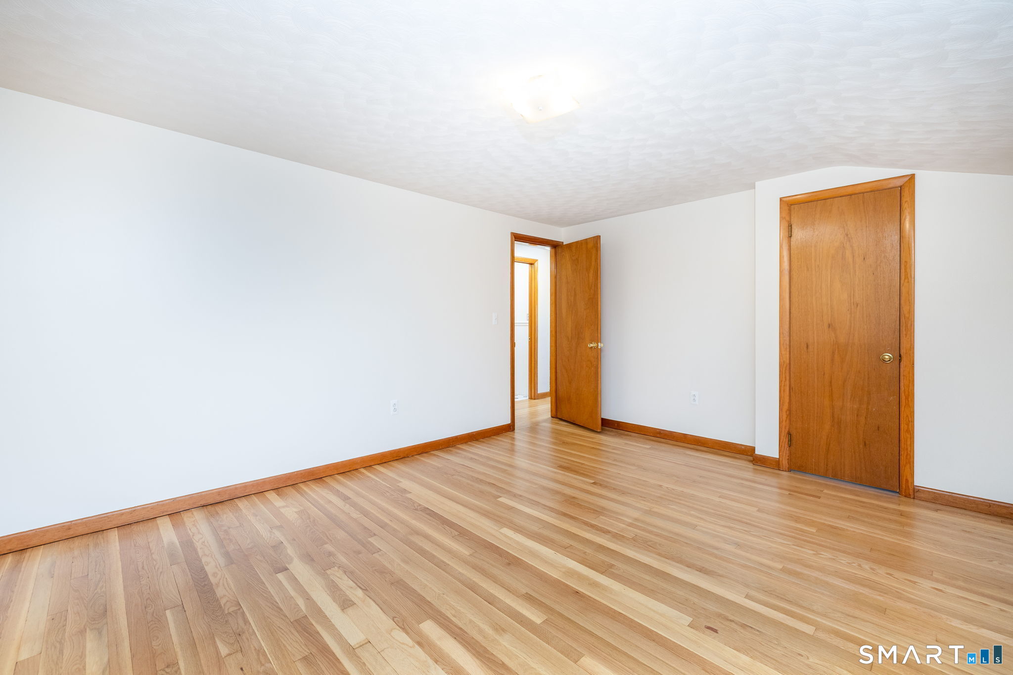 50 Brook Road Enfield, CT 06082 - Photo 18 of 34 a view of an empty room with wooden floor and a window