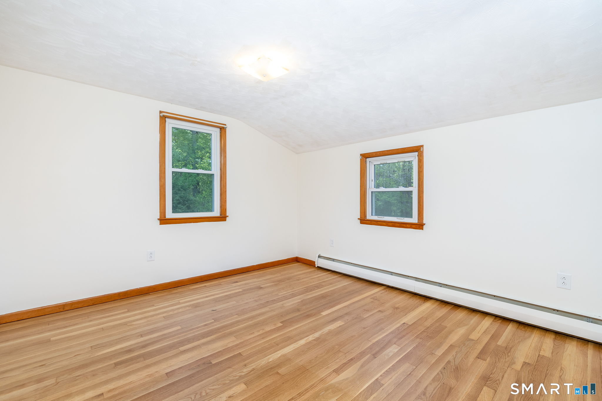 50 Brook Road Enfield, CT 06082 - Photo 19 of 34 an empty room with wooden floor and windows