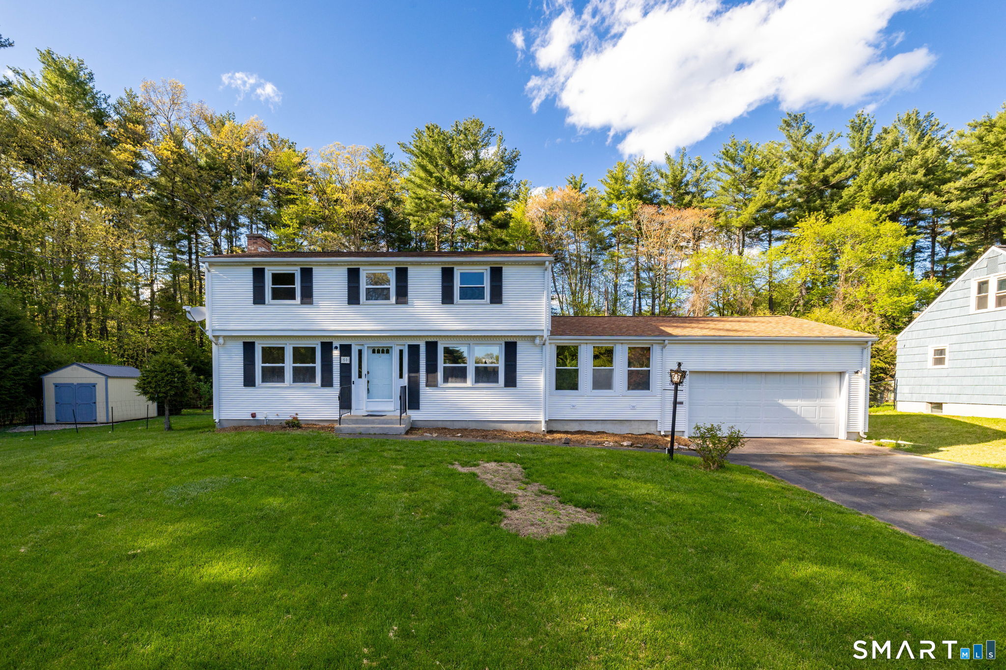 50 Brook Road Enfield, CT 06082 - Photo 2 of 34 a view of a house with a yard deck and sitting area