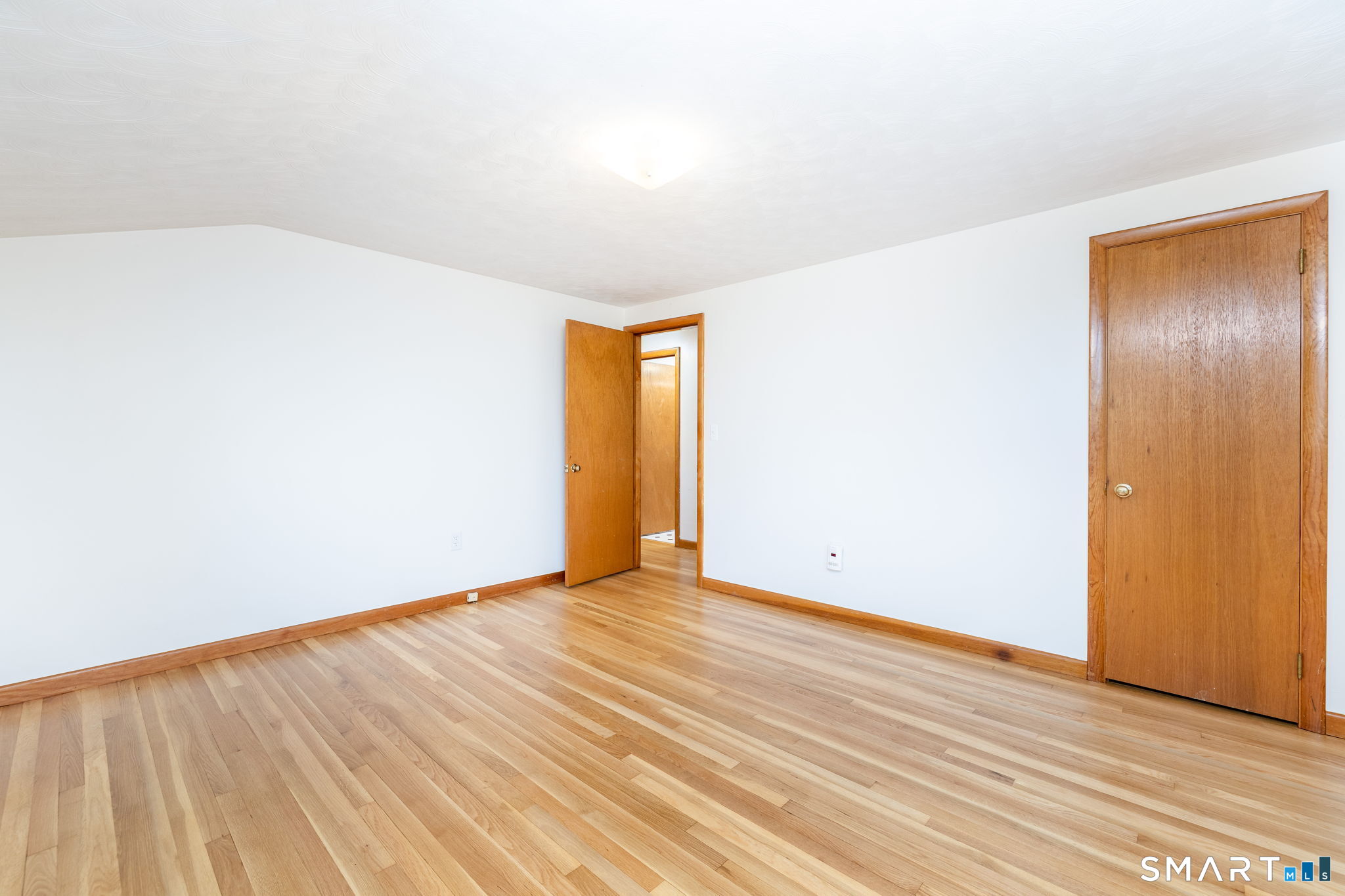 50 Brook Road Enfield, CT 06082 - Photo 22 of 34 a view of an empty room with wooden floor and a window