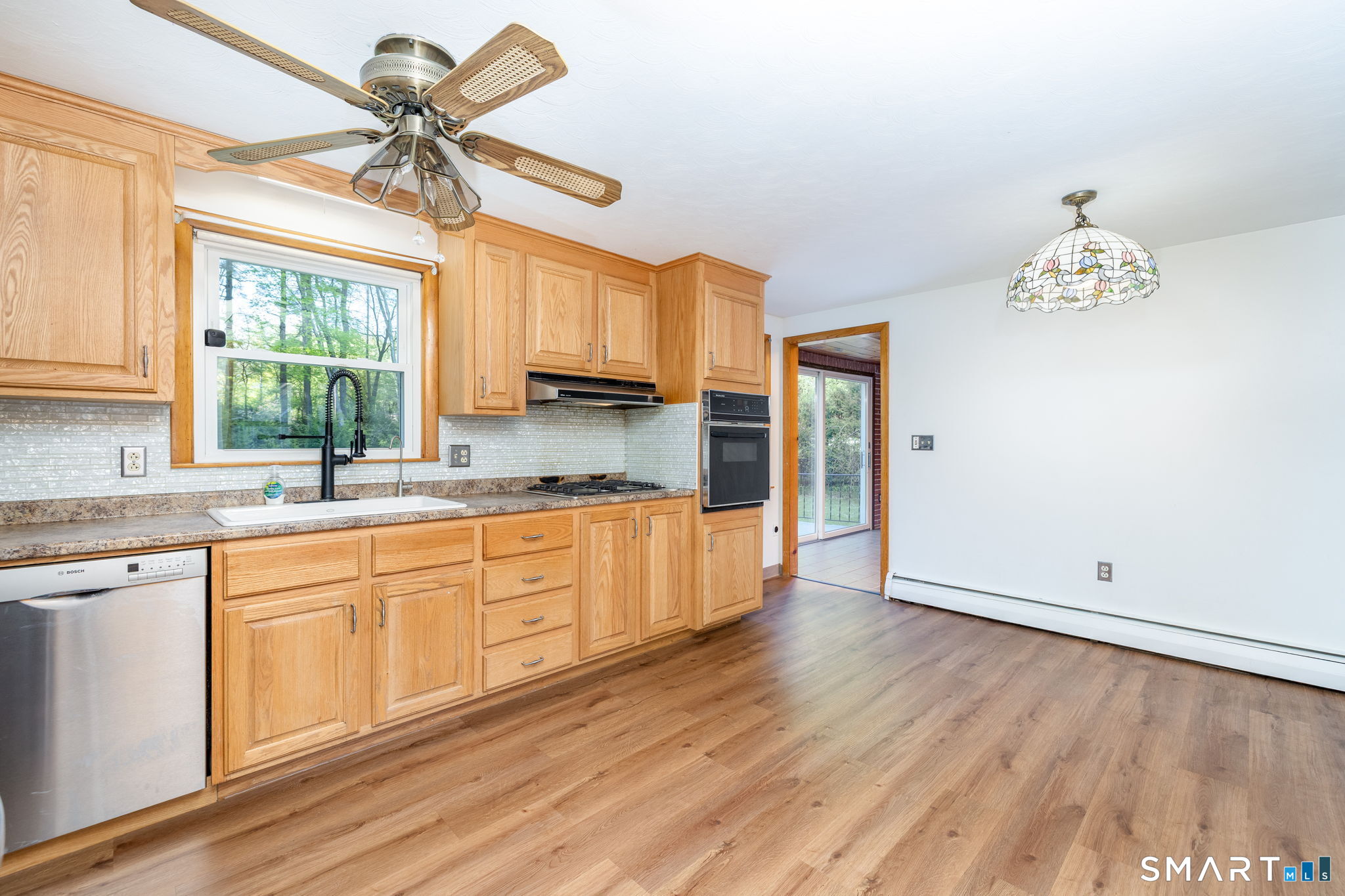 50 Brook Road Enfield, CT 06082 - Photo 7 of 34 a large kitchen with a wooden floor and a window