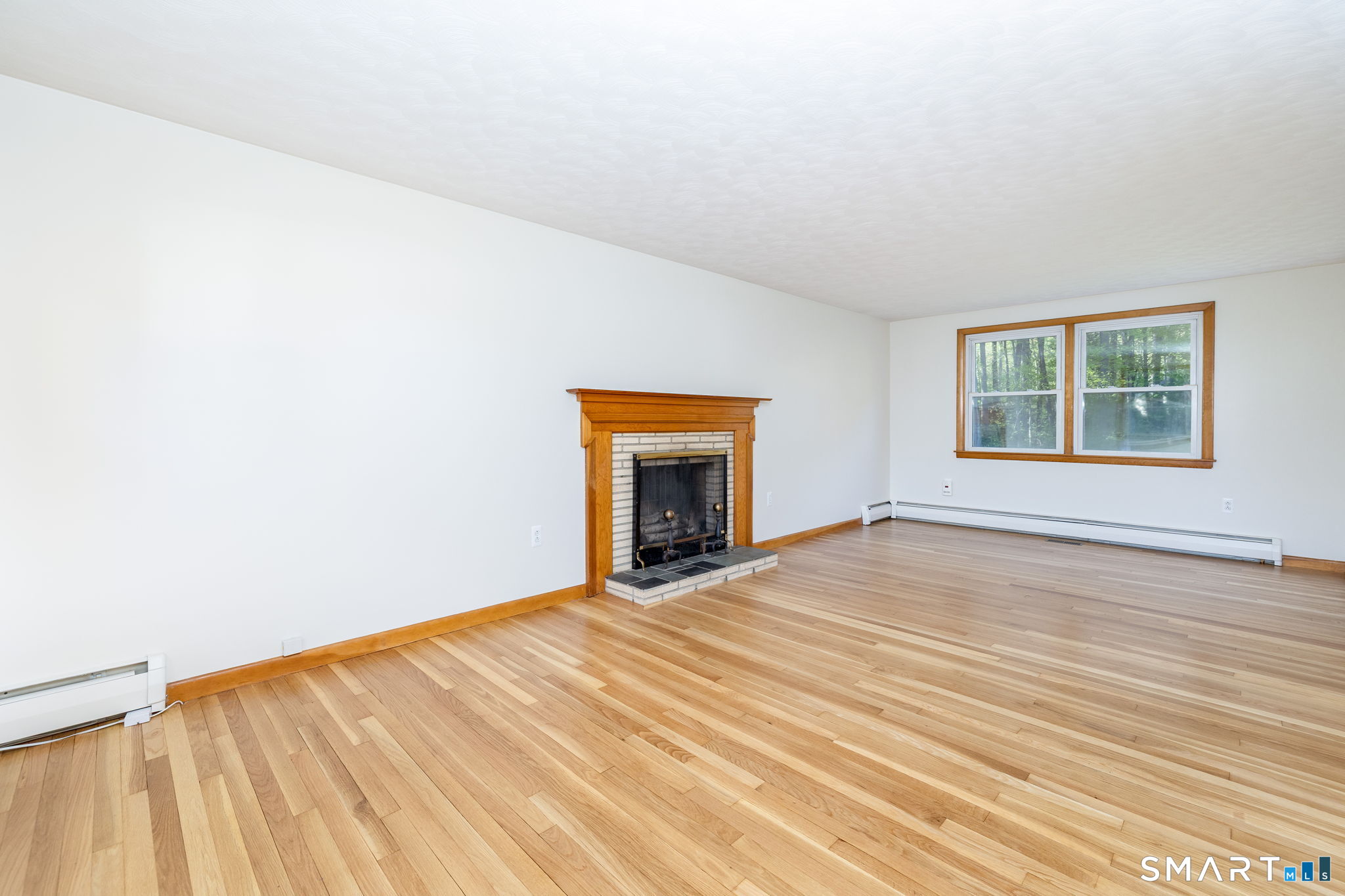 50 Brook Road Enfield, CT 06082 - Photo 9 of 34 an empty room with wooden floor and a window