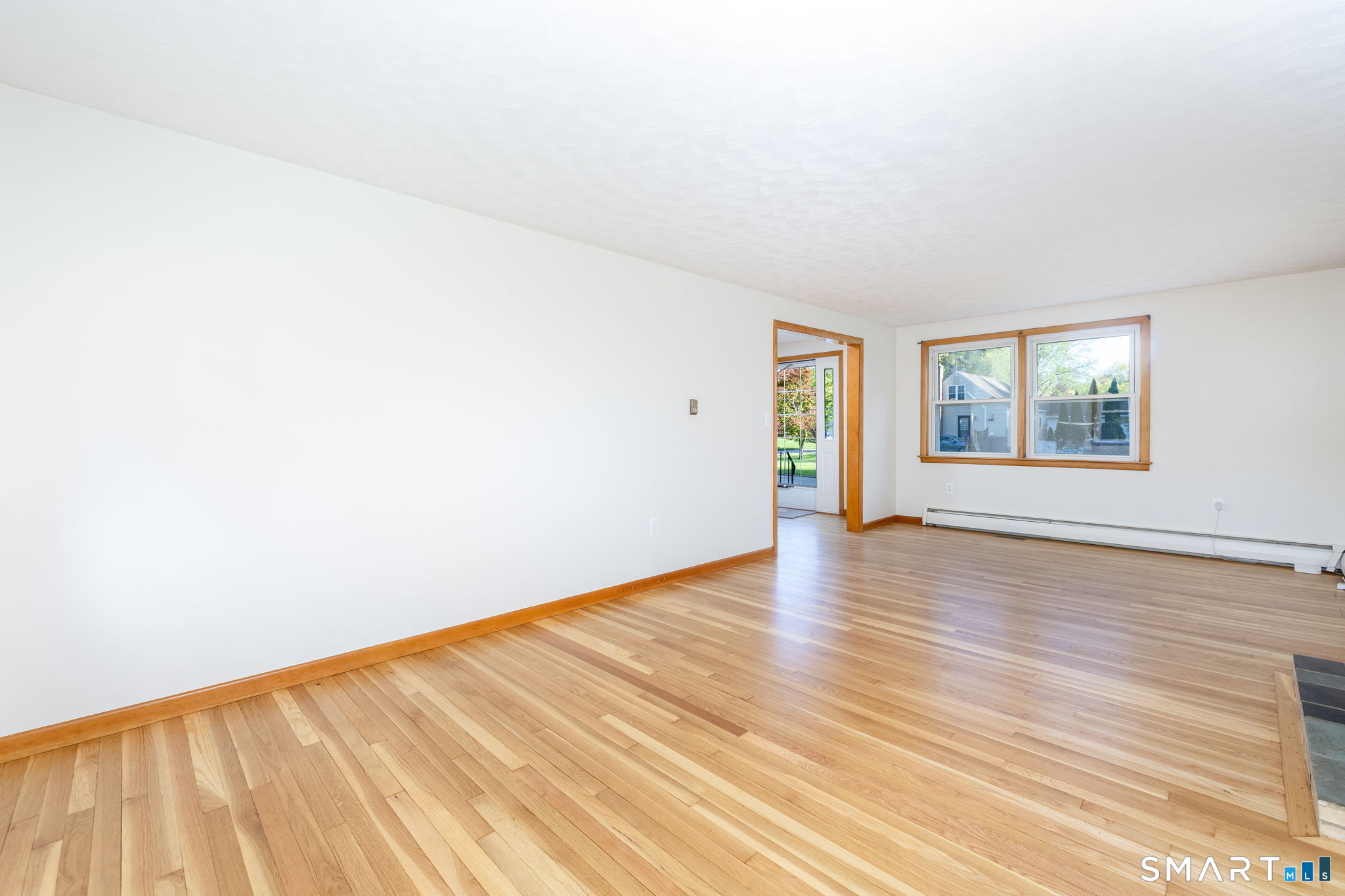 50 Brook Road Enfield, CT 06082 - Photo 10 of 34 an empty room with wooden floor and windows