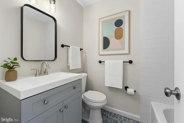 a bathroom with a toilet sink and mirror