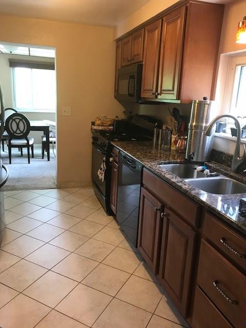22 Seneca Road Pittsburgh, PA 15241 - Photo 6 of 24 Kitchen with granite counters, double bowl stainless steel sink, built-in microwave and gas stove.