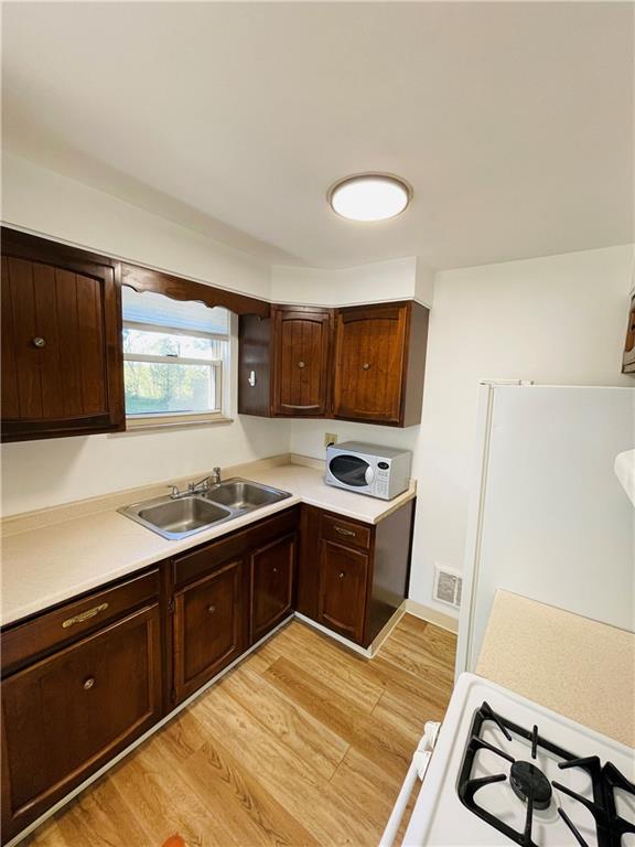 8149 Peebles Road Pittsburgh, PA 15237 - Photo 17 of 36 a kitchen with stainless steel appliances granite countertop a sink stove and refrigerator