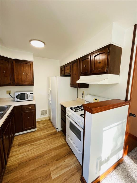 8149 Peebles Road Pittsburgh, PA 15237 - Photo 18 of 36 a kitchen with stainless steel appliances a stove a microwave and a refrigerator
