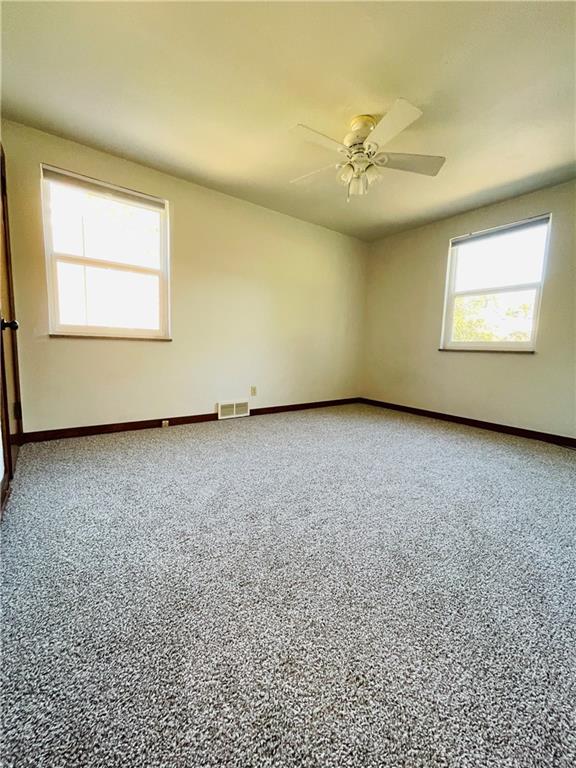 8149 Peebles Road Pittsburgh, PA 15237 - Photo 24 of 36 an empty room with a chandelier fan and windows