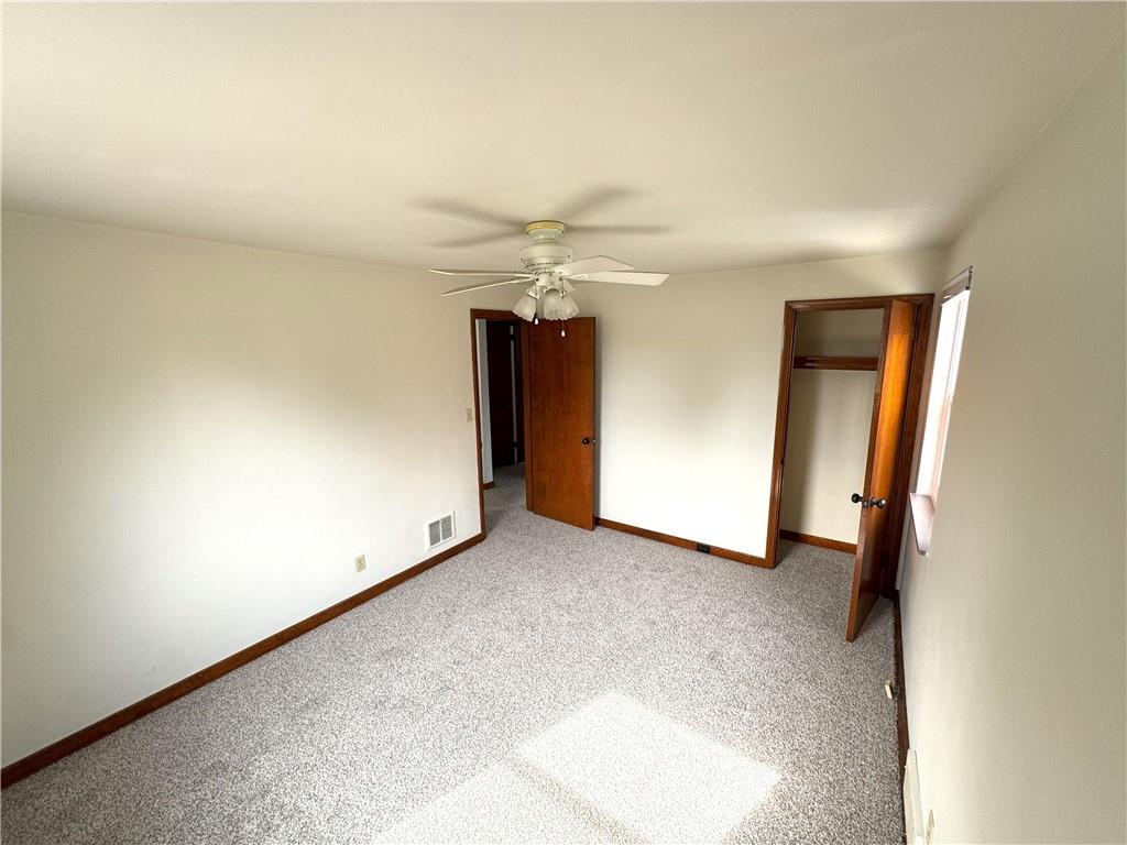 8149 Peebles Road Pittsburgh, PA 15237 - Photo 26 of 36 an empty room with a ceiling fan and closet