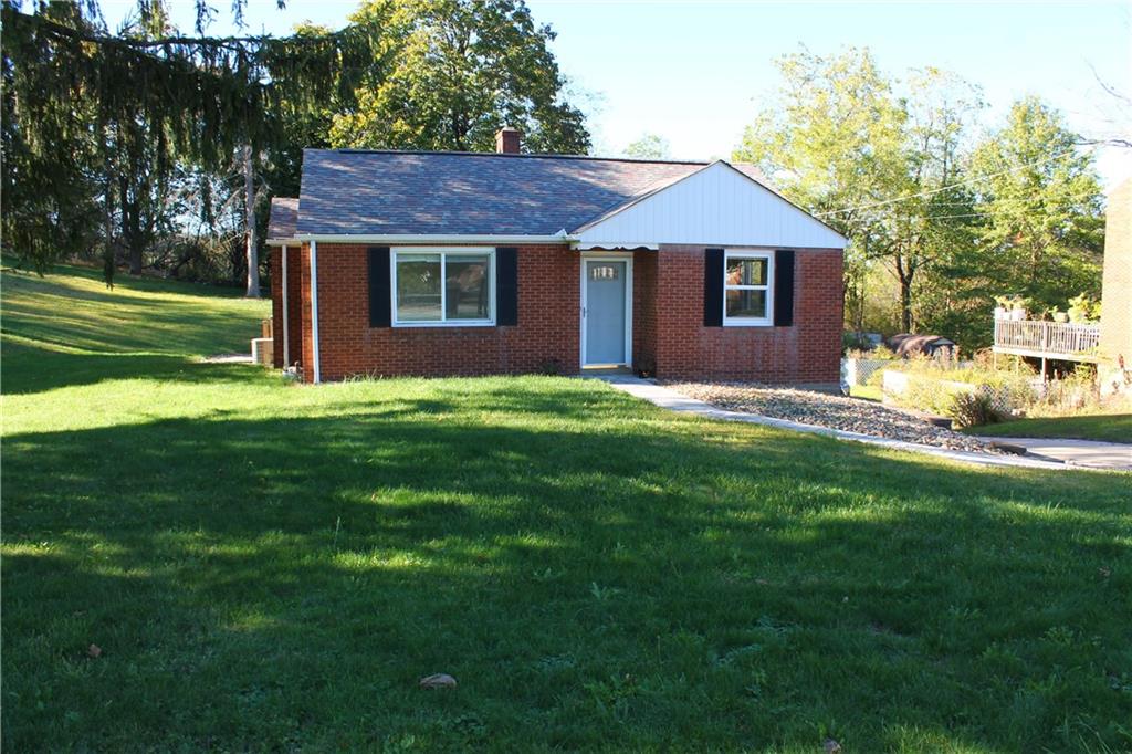 8149 Peebles Road Pittsburgh, PA 15237 - Photo 3 of 36 a front view of a house with a garden and yard