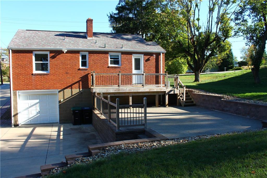 8149 Peebles Road Pittsburgh, PA 15237 - Photo 9 of 36 a front view of a house with a yard table and chairs