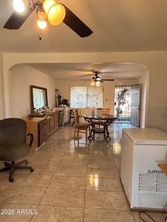 a living room with furniture and a large mirror