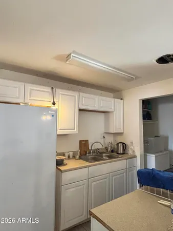 a kitchen with a sink a stove and cabinets