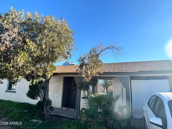 a front view of a house with plants