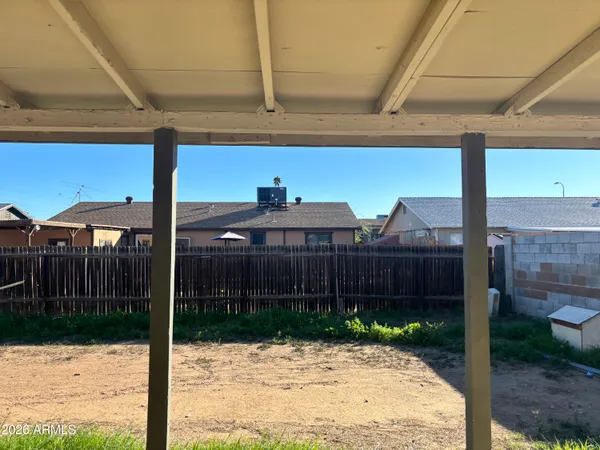 a view of a brick house with a small yard