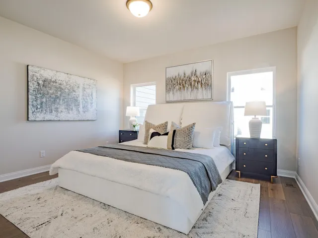 a bedroom with a bed and a painting on the wall