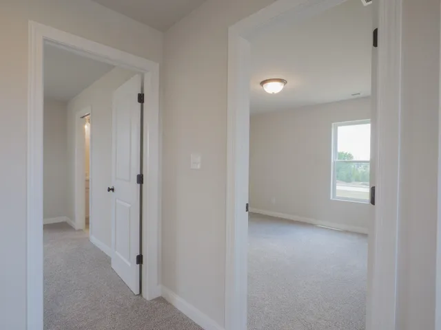 an empty room with windows and closet area