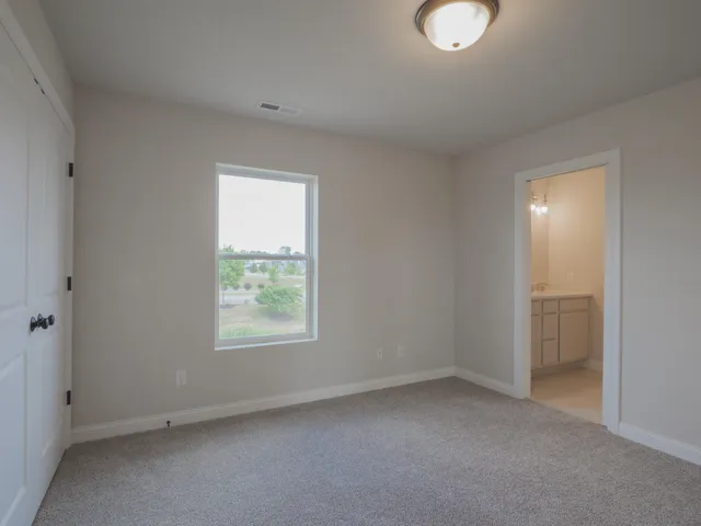 a view of a hallway with entryway door and stairs