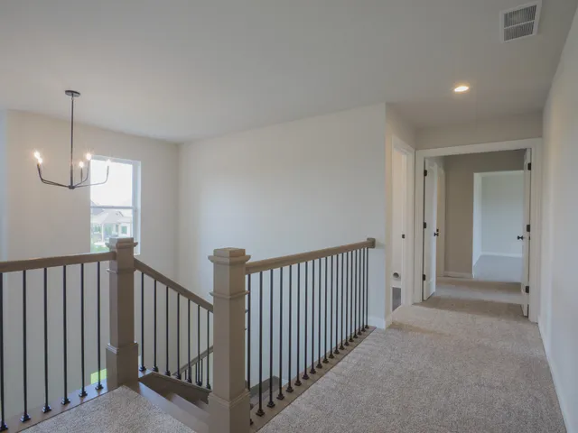 a view of a room with wooden floor and windows