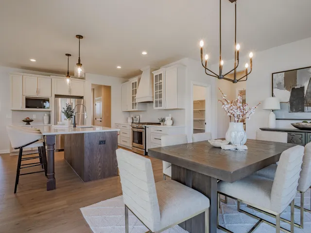 a view of kitchen with cabinets table and chairs