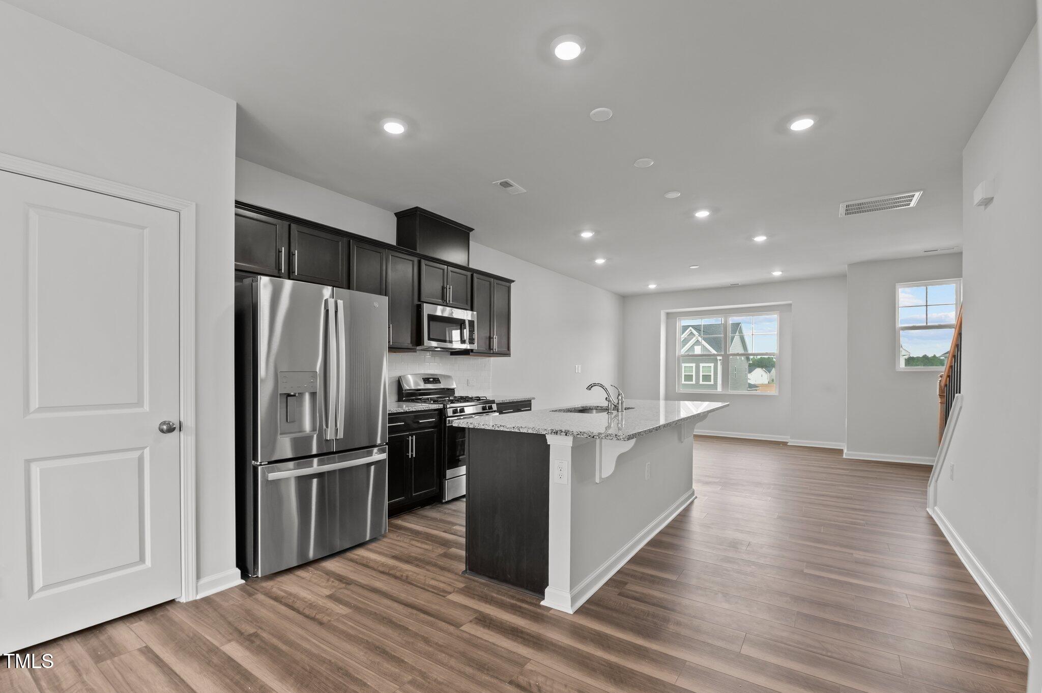 Undisclosed Address Wake Forest, NC 27587 - Photo 15 of 35 a kitchen with stainless steel appliances granite countertop a refrigerator and a stove top oven