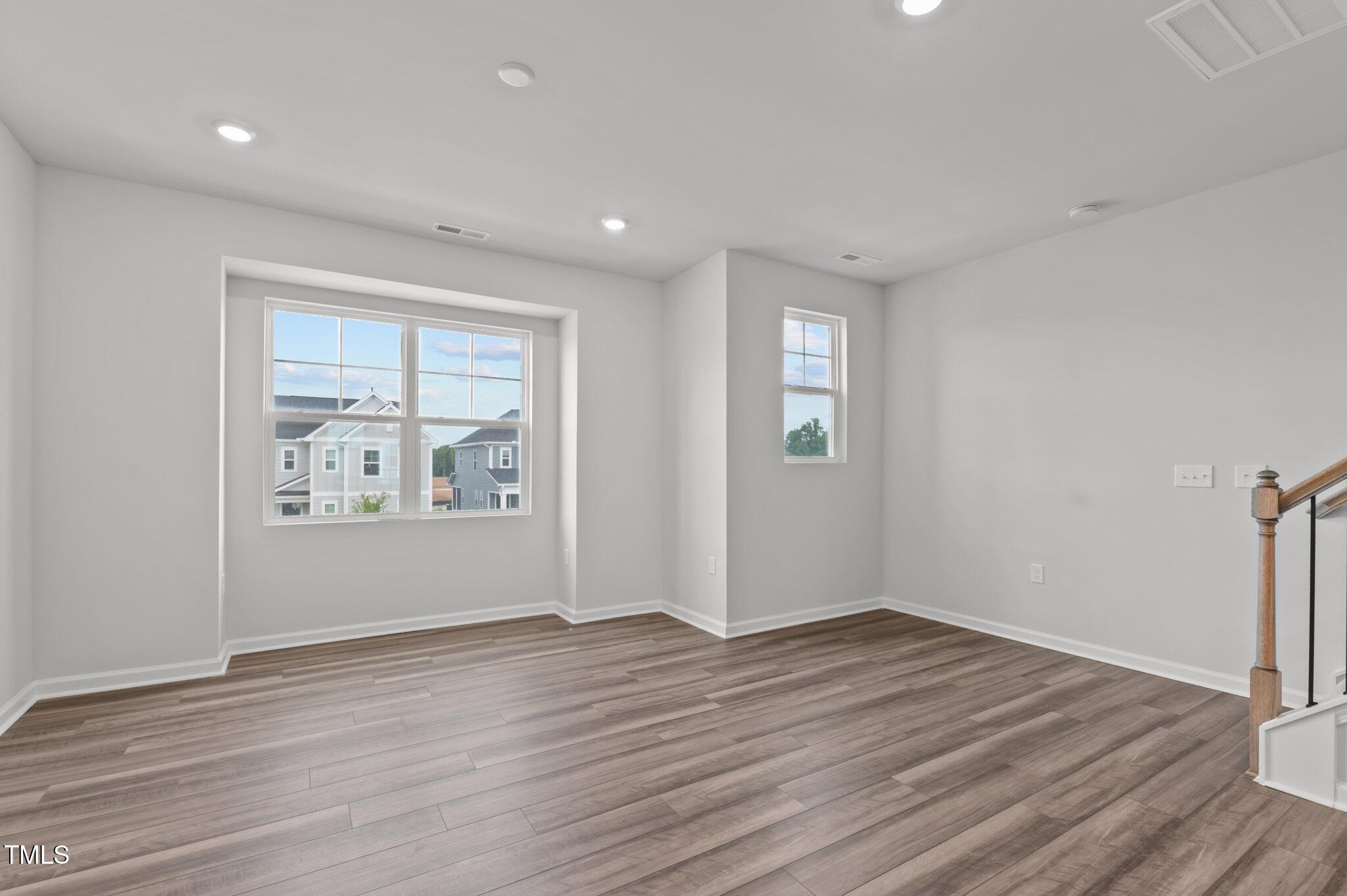Undisclosed Address Wake Forest, NC 27587 - Photo 20 of 35 wooden floor in an empty room with a window