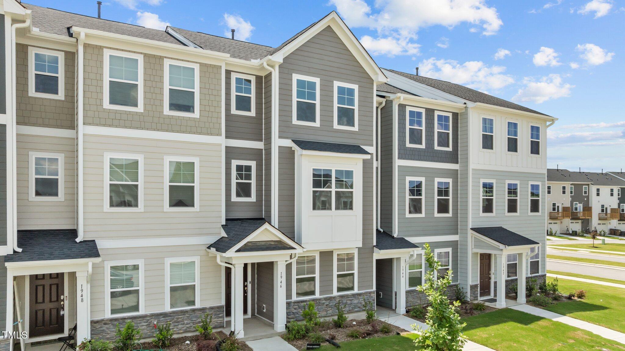 Undisclosed Address Wake Forest, NC 27587 - Photo 3 of 35 a front view of a residential apartment building with a yard