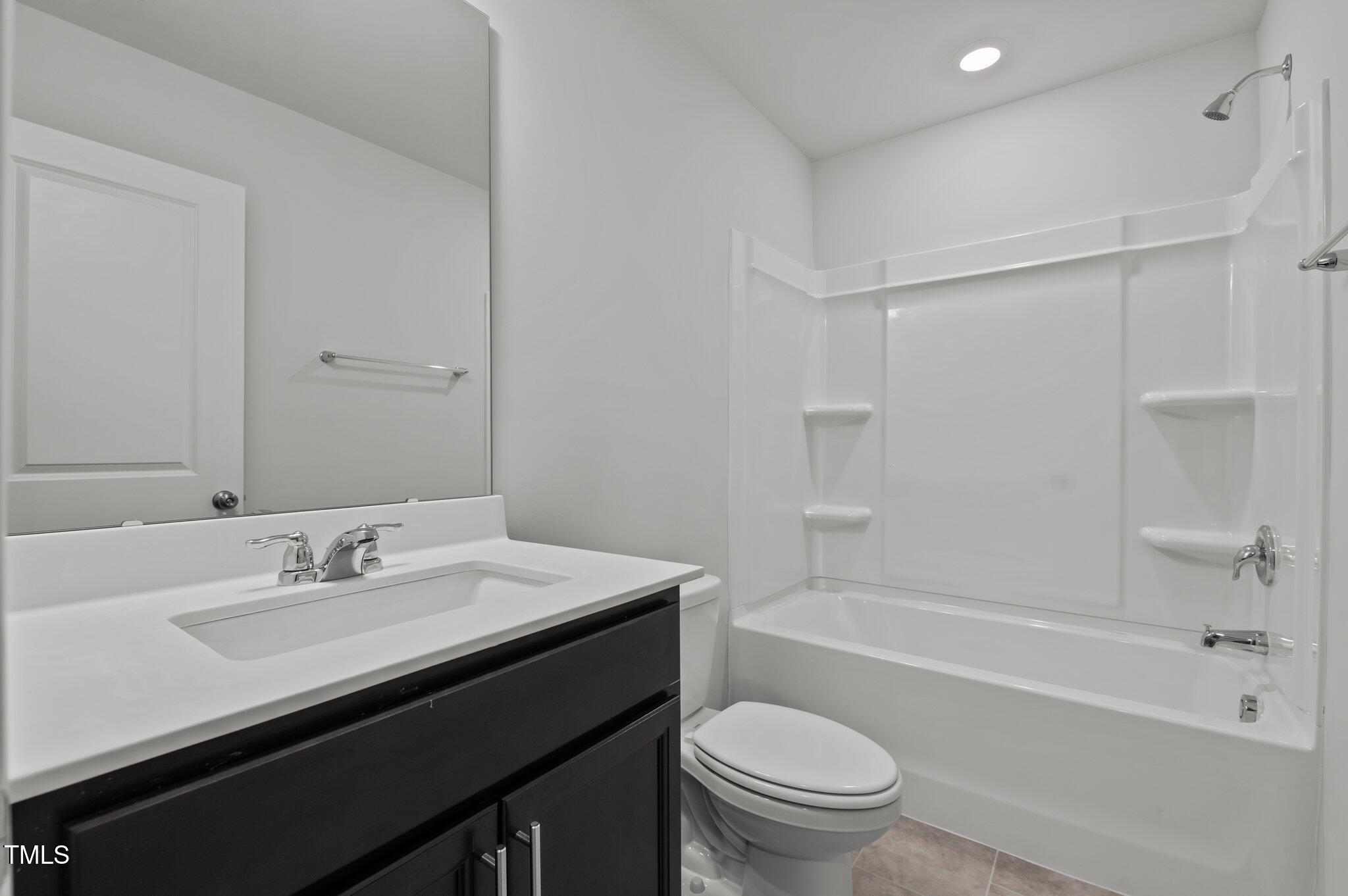 Undisclosed Address Wake Forest, NC 27587 - Photo 9 of 35 a bathroom with a sink a toilet and shower