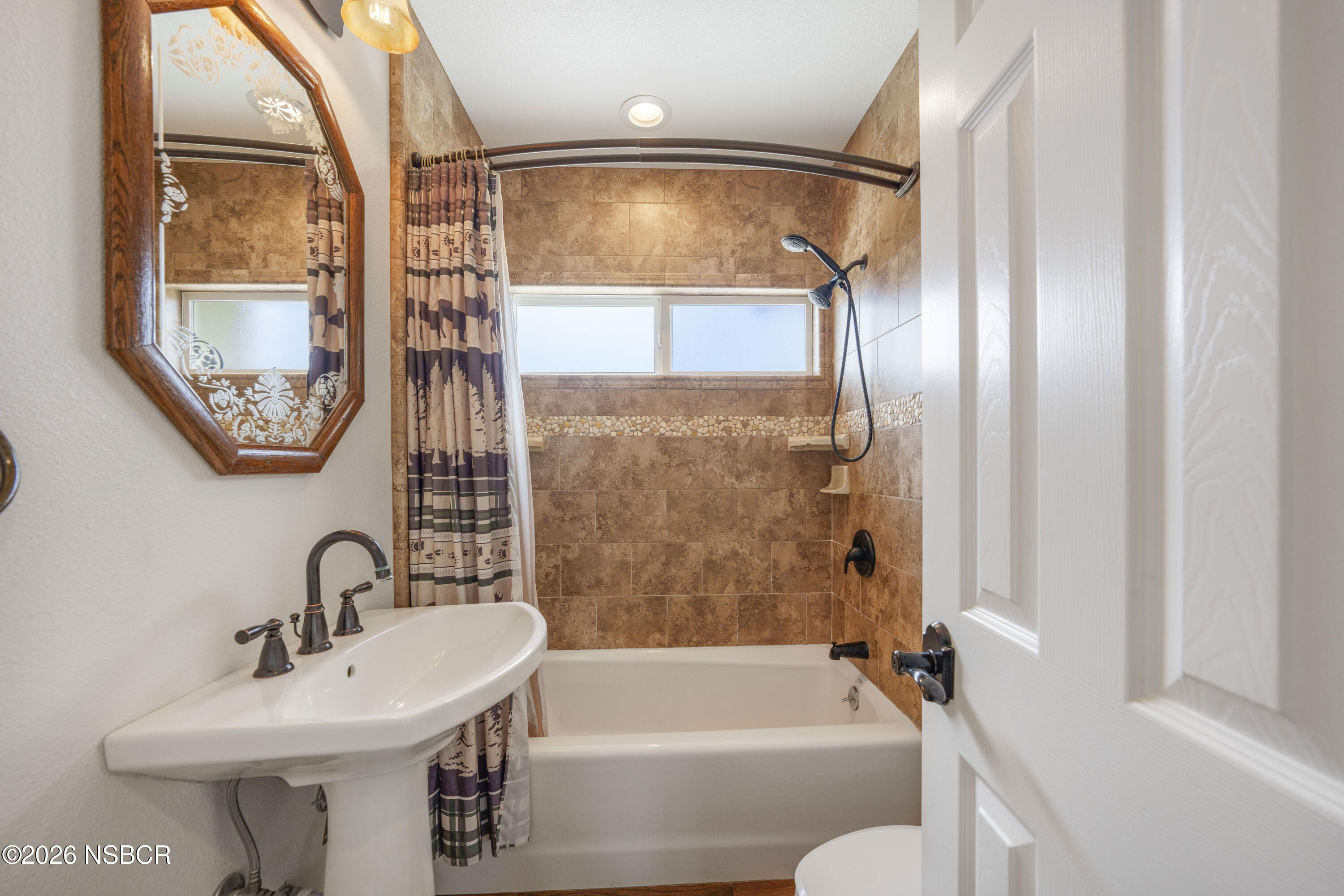 138 North E Street Lompoc, CA 93436 - Photo 16 of 35 a bathroom with a sink toilet and shower