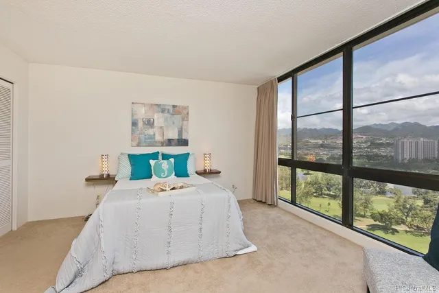 a bedroom with a bed and a large window