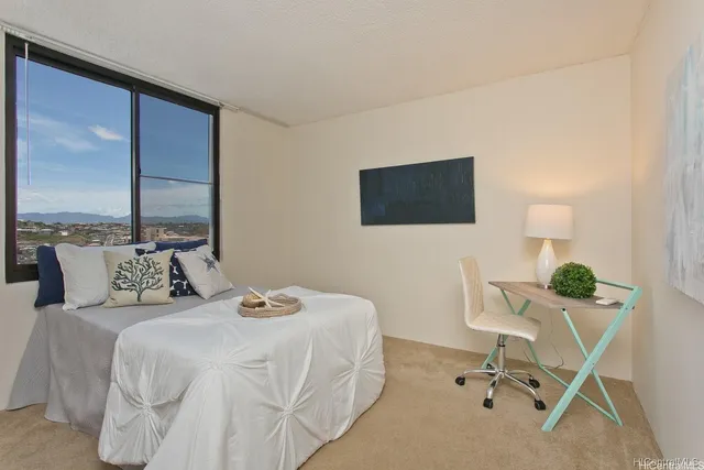 a bedroom with a bed a desk and chair