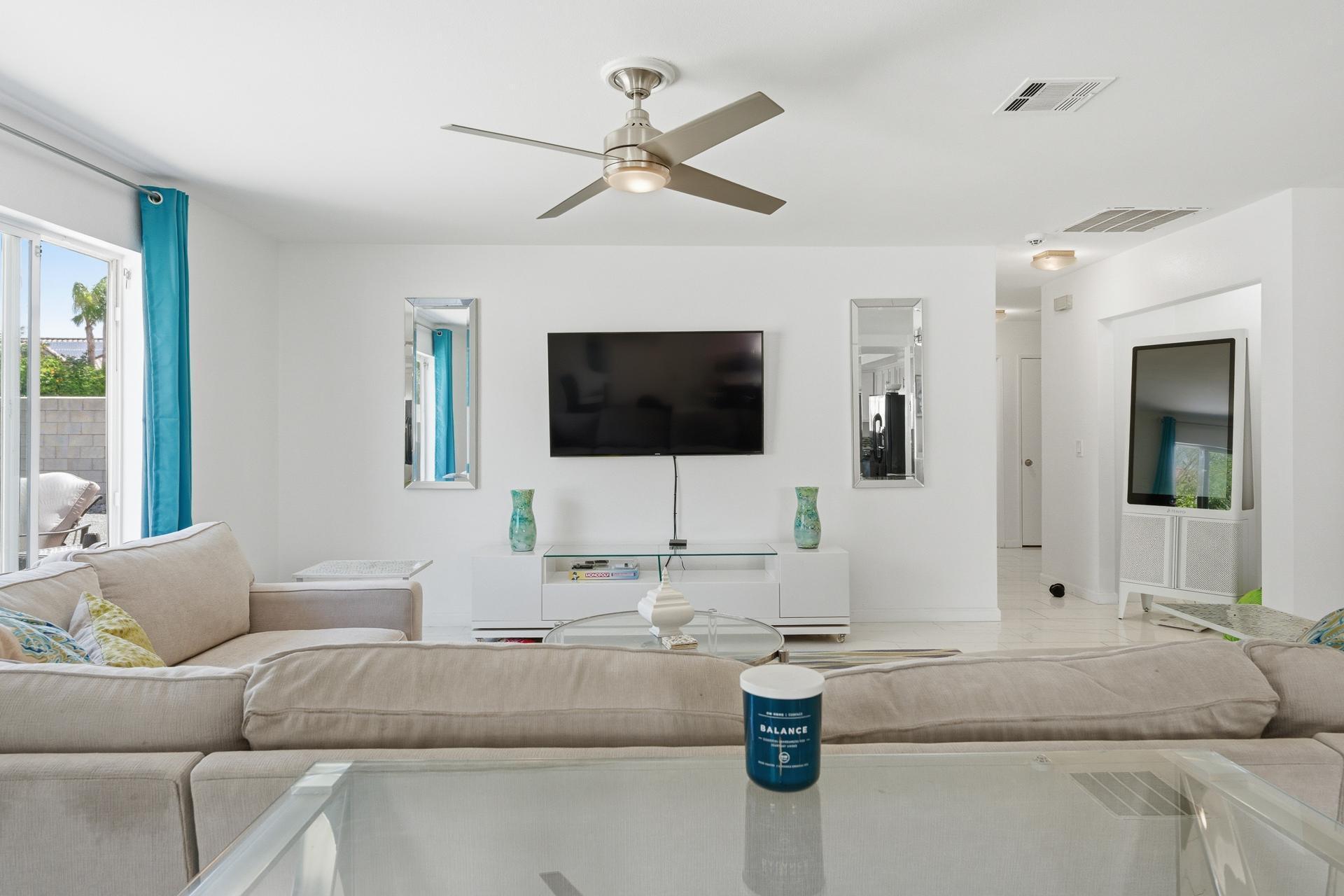 67220 Quijo Road Cathedral City, CA 92234 - Photo 21 of 26 a living room with furniture and a flat screen tv