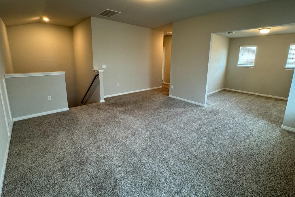 12604 Dairywork Road Buda, TX 78610 - Photo 11 of 20 A spacious carpeted living area provides a versatile foundation for any interior design vision.